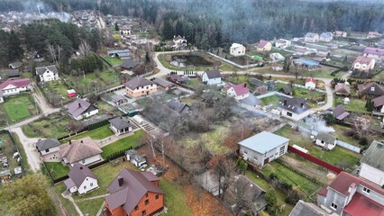 Panorama, aerial view of a cottage village in Russia, Eastern Europe. Cottage village with residential development, private houses and small plots of land for auxiliary farming.