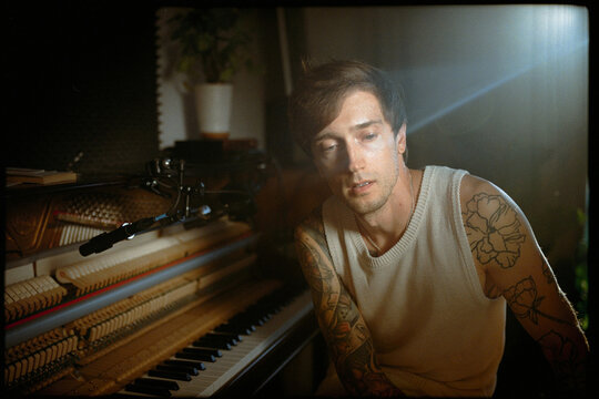 Portrait of a thoughtful musician or composer near the piano