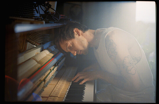 The musician plays the piano sensually