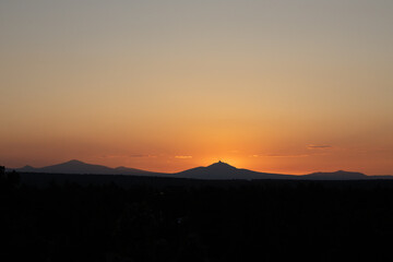 Sunset glow behind mountain range in Oregon