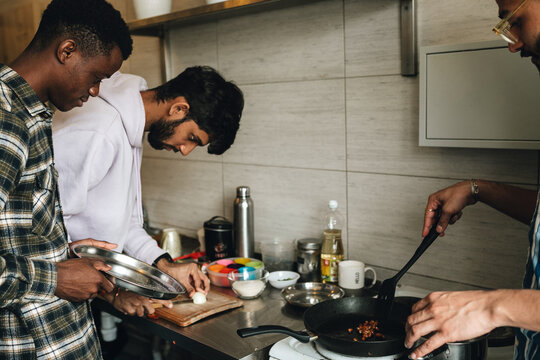 Students cooking at the hostel kitchen together.