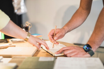 Hands sketching and collaborating on a design project