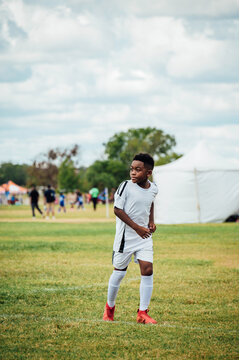 Boy playing soccer on field