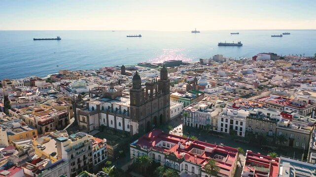 Aerial 4K video from drone to cityscape of Las Palmas , featuring the Cathedral of Santa Ana at sunrise. Las Palmas de Gran Canaria, Canary Islands, Spain