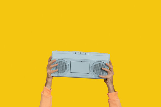 Blue boombox stereo held by hands. Music concept.