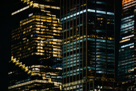 Illuminated office buildings at night in New York City close-up