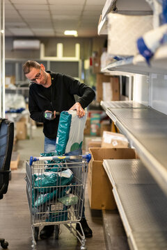 Package shop employee scanning and arranging  and packages
