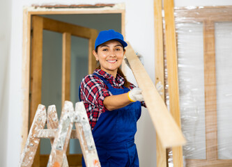 Female worker installing door jambs in a room being renovated