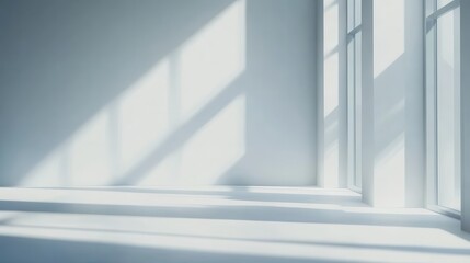 Obraz premium Bright sunlight streaming through large windows in a minimalistic interior during the day
