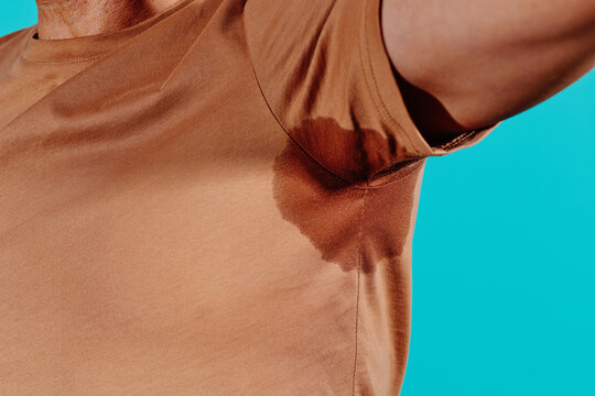 man has a stain of sweat under his armpit