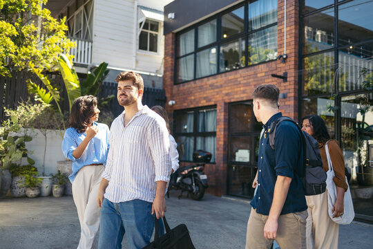 Coworkers saying goodbye at the office door