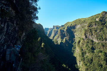 Hikers explore a stunning mountainous landscape during a clear day in a remote canyon