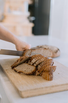 Sliced pieces of round bread on a wooden cutting board.