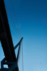 Fototapeta premium Bridge structure stretching skyward under clear blue sky at dusk