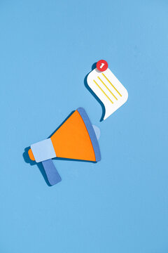Creative Megaphone Design with Notification Symbol on Blue Background