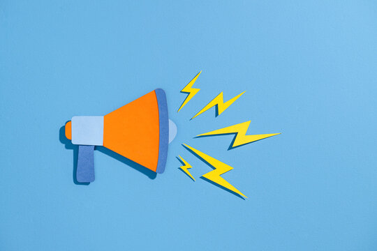 Colorful Megaphone with Lightning Bolts on Blue Background