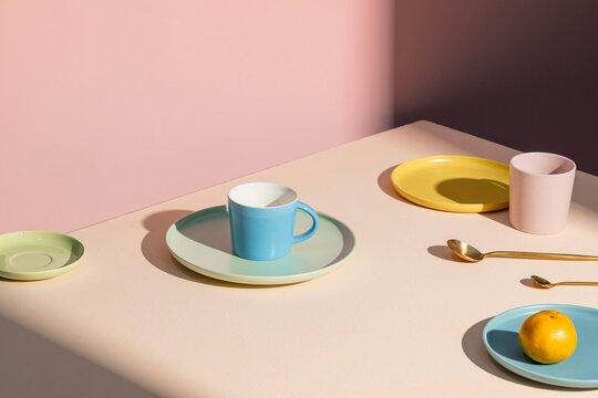 Minimalist Table Setting with Colorful Plates and Utensils