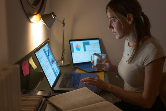 Woman working late on laptop at home office