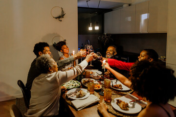 Happy family toasting during holiday dinner at home