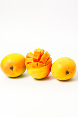 Three whole and sliced ​​ripe mango fruit isolated on white background, fresh mango