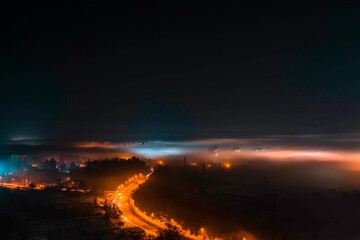 Winter Night in Shumen, Bulgaria: A Foggy Cityscape Illuminated by Warm Streetlights