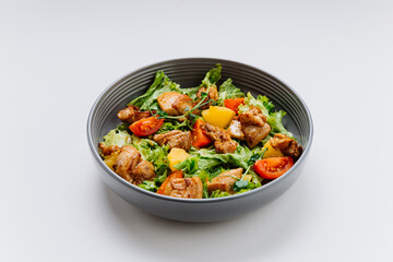 Fresh chicken salad with lettuce, cherry tomatoes, and citrus, perfect for a light and healthy meal
