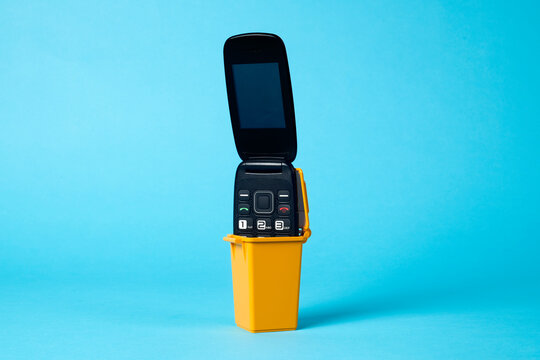 cellular phone in a trash container