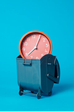 clock in a gray garbage container
