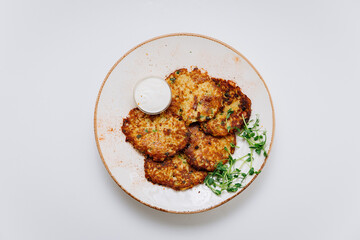 Crispy potato pancakes with sour cream and fresh greens, perfect as a savory side or appetizer