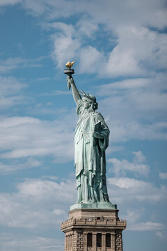 Statue of Liberty against blue sky with clouds in New York City