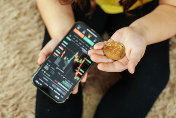 Obraz premium Young Girl Holding Bitcoin, Symbol of Digital Future