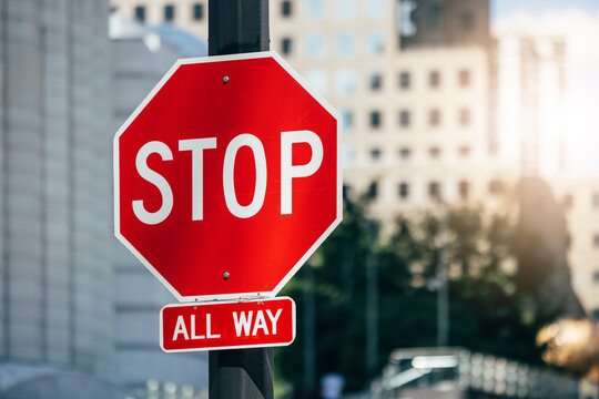 Stop sign in bustling New York with blurred building background
