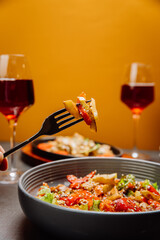 Savoring a colorful vegetable salad with red wine for a perfect gourmet dining experience