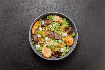 Gourmet salad with blue cheese, pear slices, toasted bread, and greens, perfect fusion of flavors