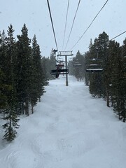 Snowy Ski Lift Ride through Mountain Pines in Winter Wonderland