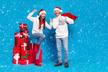 Full length body size view of attractive lucky cheerful couple delivering giftboxes dancing isolated over bright blue color background