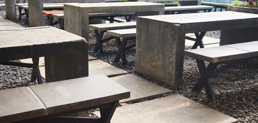 photo of outdoor cafe with cement tables and chairs, cafe in the mountains, with beautiful natural views