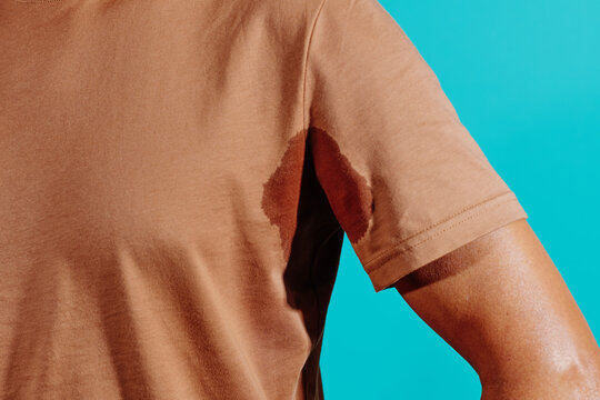 man with a wet stain of sweat under his armpit
