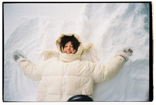 A girl lying in the snow 