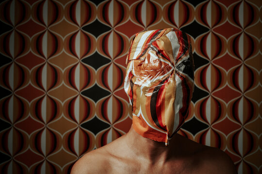 man wrapped with a geometric-patterned paper