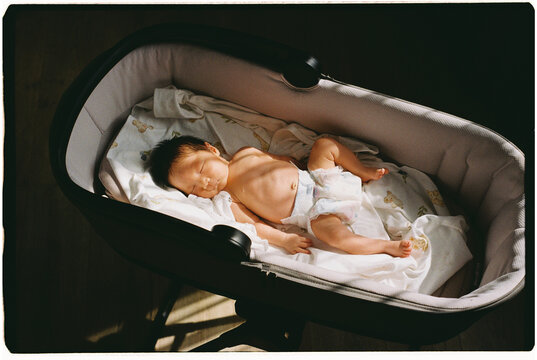 the newborn lies in the sun and gets vitamin D.