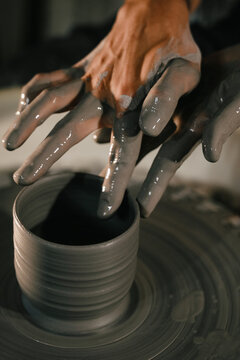 Crafting pottery on a wheel in a traditional studio setting