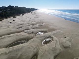 Bright sunlight shines on Agate Beach situated along the Oregon Coast Highway in the town of Newport. The beautiful beach is named after its abundance of iron oxide-colored agates found there.