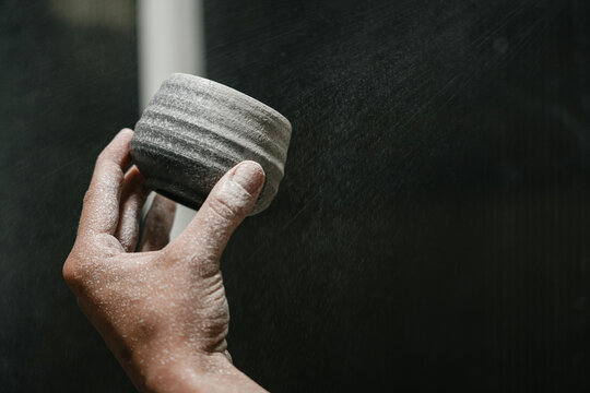 Potter crafting unique pottery pieces in a workshop setting