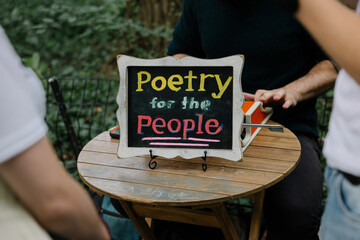 Poetry for the People shop with creative sign in NYC park