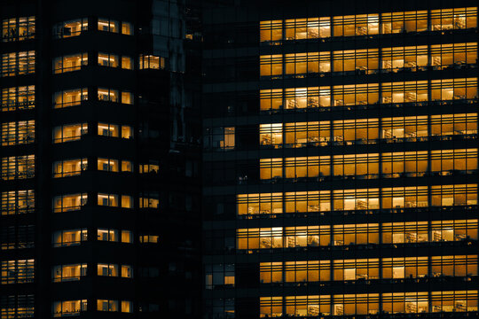 Illuminated office building windows at night in NYC