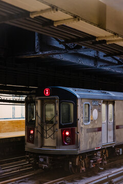 NYC subway train at station with number 2 sign