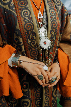 Details of a traditional outfit adorned with beautiful jewelry 
