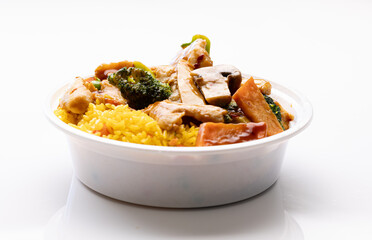 Hunan chicken Chinese takeout dish in disposable plastic bowl with fried rice.