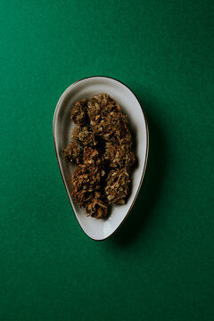 marijuana buds in a clamshell-shaped plate